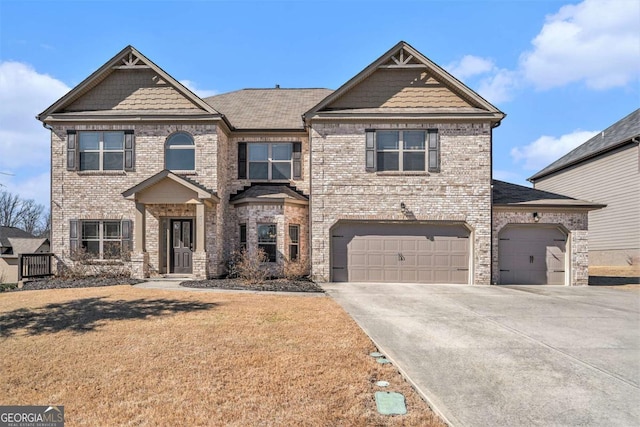 craftsman-style home featuring driveway, brick siding, and a front yard