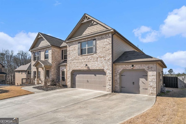 craftsman-style home with an attached garage, fence, concrete driveway, and brick siding