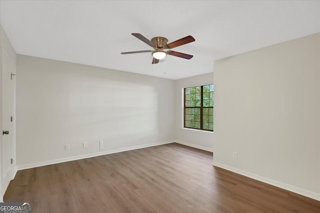 spare room with ceiling fan, baseboards, and wood finished floors