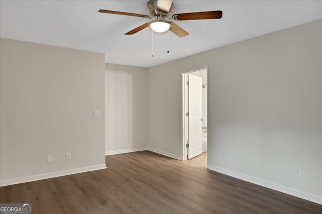 spare room with a ceiling fan, a textured ceiling, baseboards, and wood finished floors