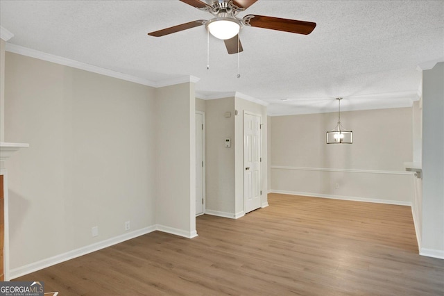 interior space featuring a textured ceiling, wood finished floors, and crown molding