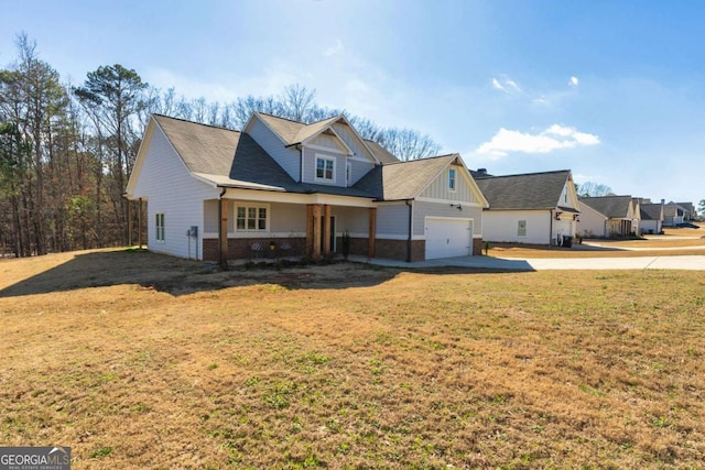 view of front of home with a front yard, concrete driveway, brick siding, and an attached garage