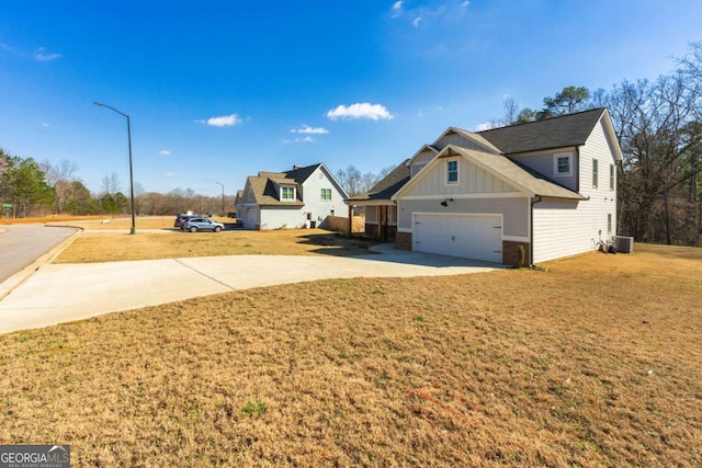 exterior space featuring a garage, driveway, and cooling unit