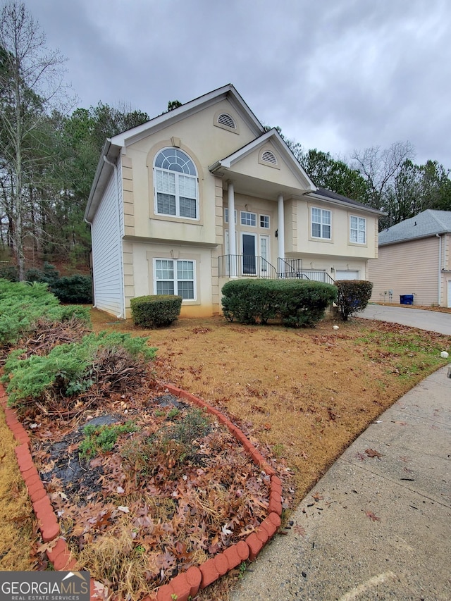 raised ranch with concrete driveway