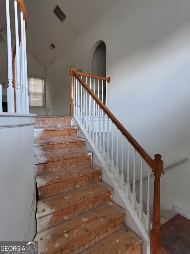 stairway with visible vents and vaulted ceiling