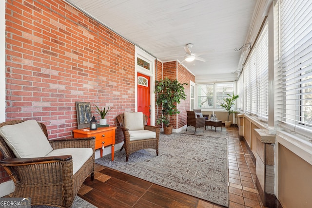 sunroom featuring a ceiling fan