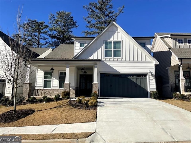 view of front of property featuring concrete driveway, a porch, board and batten siding, and stone siding