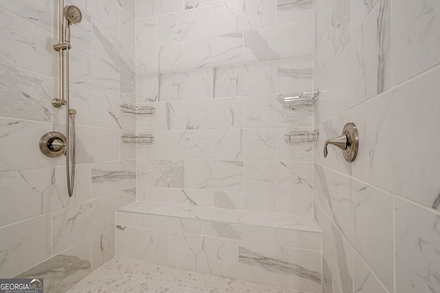 bathroom featuring a tile shower