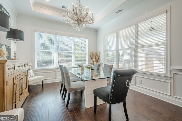 dining space featuring a decorative wall, crown molding, a raised ceiling, and visible vents