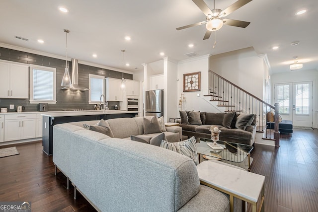 living room with recessed lighting, visible vents, dark wood finished floors, and stairway