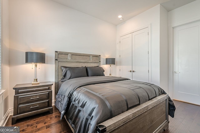 bedroom with recessed lighting, a closet, and dark wood-style floors