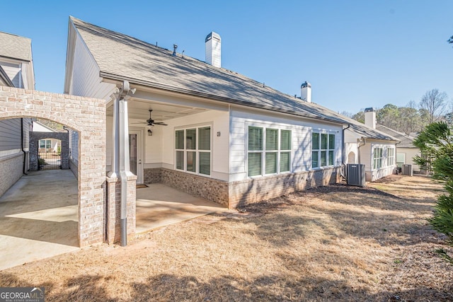 rear view of property with a patio, cooling unit, a shingled roof, brick siding, and ceiling fan