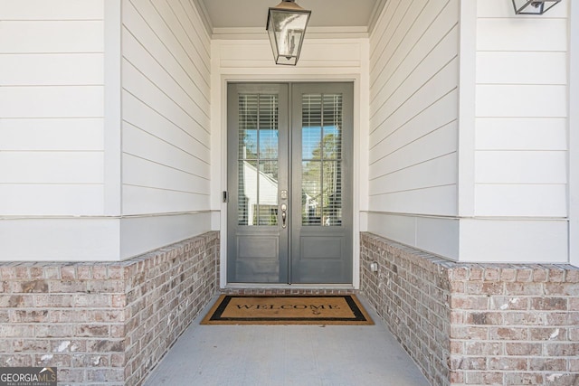 property entrance with french doors and brick siding