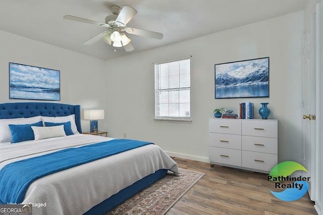 bedroom featuring ceiling fan, wood finished floors, and baseboards