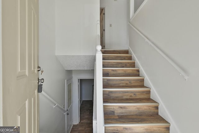 staircase featuring wood finished floors