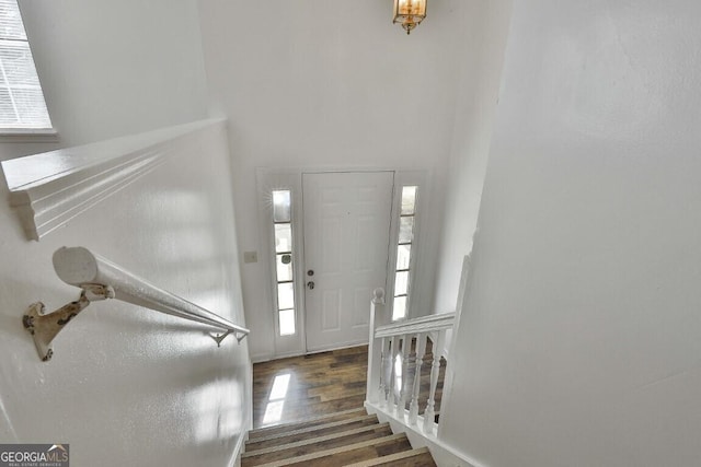 entrance foyer featuring stairs and wood finished floors