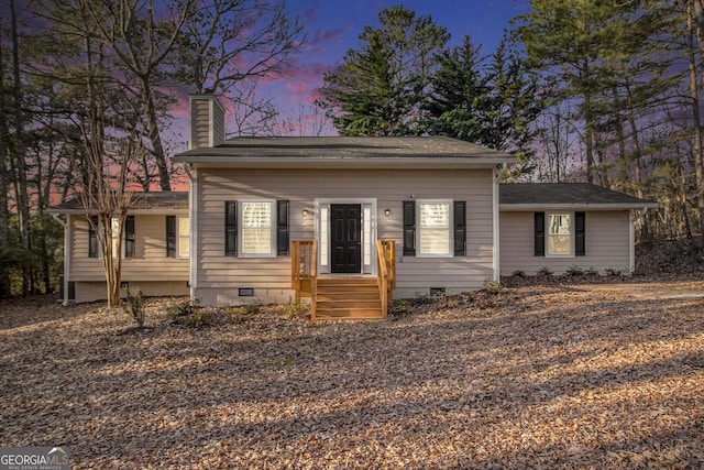 view of front of house with crawl space and a chimney