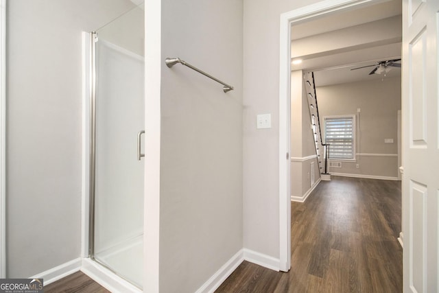 full bath featuring a stall shower, ceiling fan, and wood finished floors