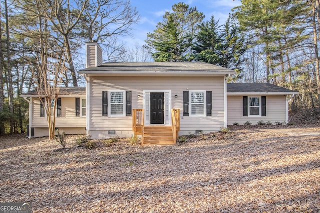 view of front of home with crawl space and a chimney