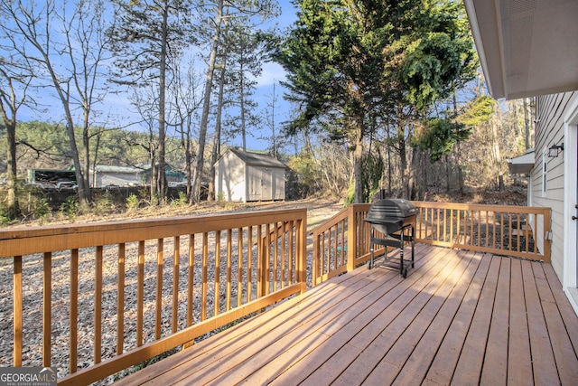 deck with a storage shed, a grill, and an outdoor structure