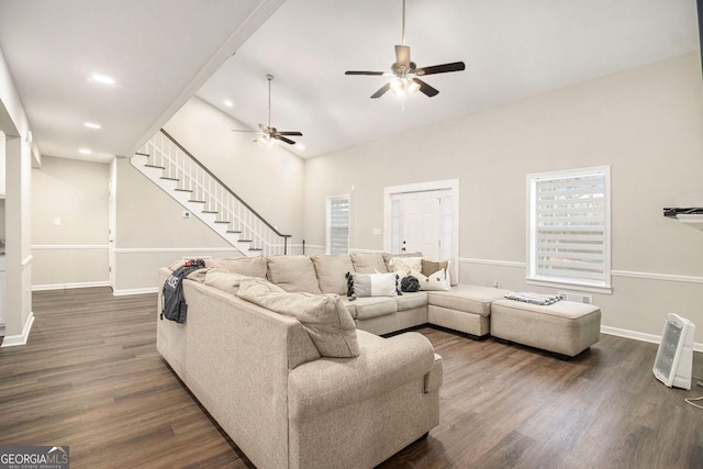 living room with stairs, baseboards, dark wood-type flooring, and recessed lighting