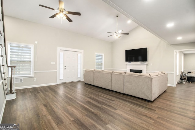 unfurnished living room featuring dark wood-style floors, a fireplace, visible vents, a ceiling fan, and high vaulted ceiling