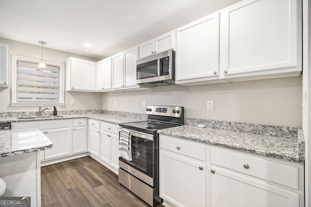 kitchen with white cabinetry, stainless steel appliances, and a sink