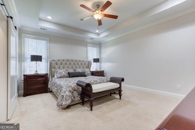 carpeted bedroom featuring a tray ceiling, recessed lighting, visible vents, ceiling fan, and baseboards