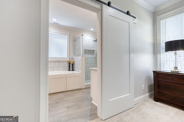 bathroom with a healthy amount of sunlight, a garden tub, and tiled shower