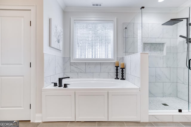 bathroom featuring ornamental molding, a stall shower, visible vents, and a garden tub