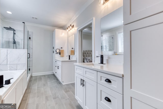 full bathroom featuring ornamental molding, two vanities, a sink, and a shower stall