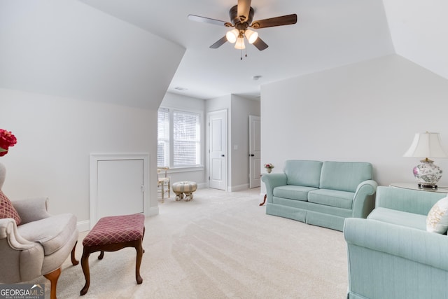 living area featuring vaulted ceiling, carpet floors, a ceiling fan, and baseboards