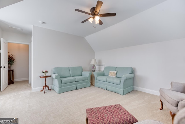 living area featuring lofted ceiling, ceiling fan, baseboards, and carpet flooring