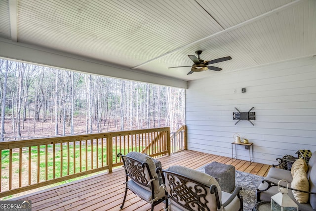 wooden terrace with a ceiling fan