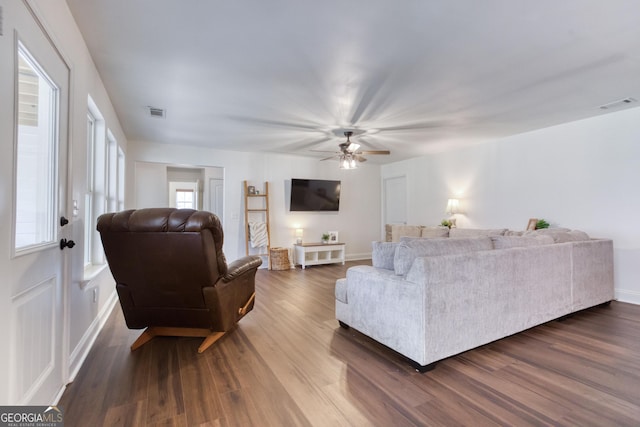 living room featuring ceiling fan, dark wood-style flooring, and visible vents