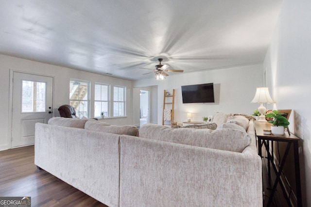 living room featuring dark wood-style floors and a ceiling fan