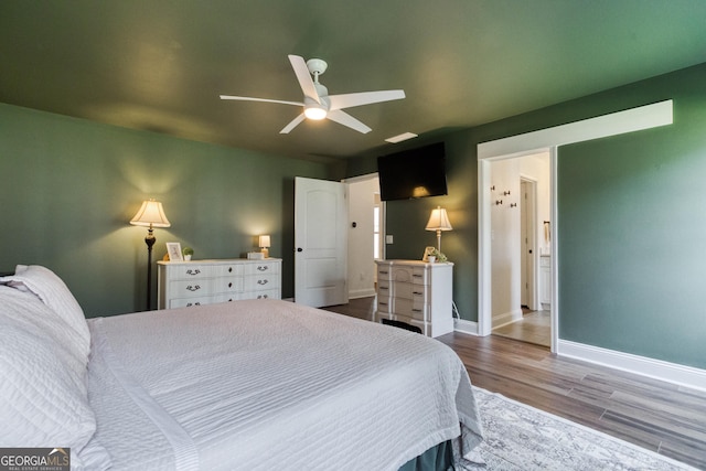 bedroom featuring ceiling fan, baseboards, and wood finished floors