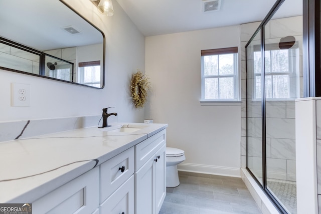 full bath with toilet, a stall shower, visible vents, and a wealth of natural light