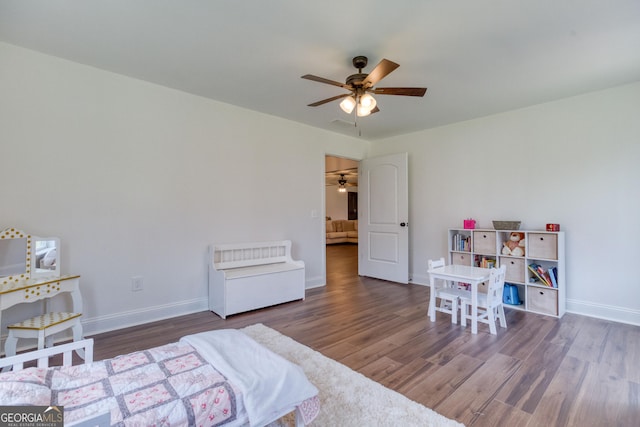 bedroom with ceiling fan, baseboards, and wood finished floors