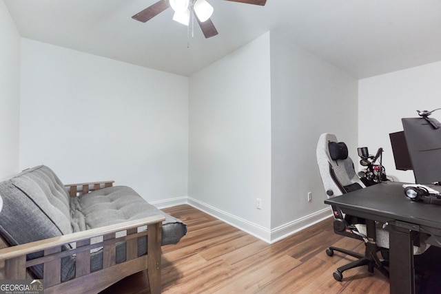 office with light wood-type flooring, baseboards, and a ceiling fan