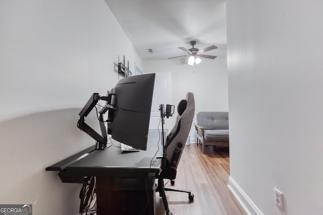 office featuring ceiling fan, baseboards, and wood finished floors