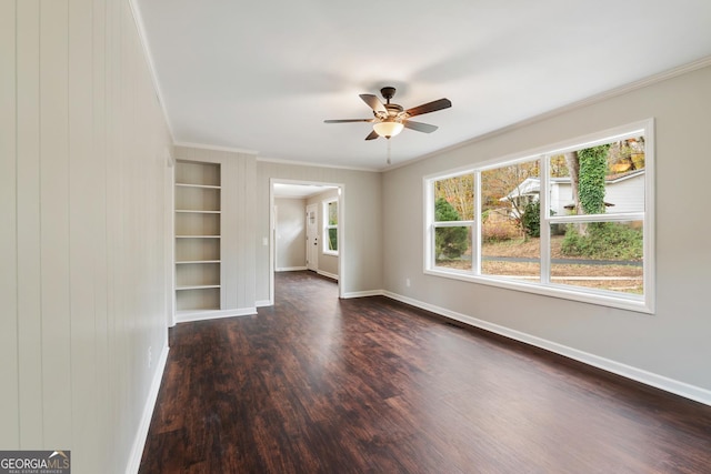 interior space with baseboards, dark wood-style flooring, a ceiling fan, and crown molding