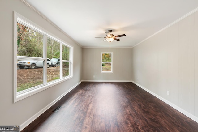 unfurnished room with baseboards, ornamental molding, ceiling fan, and dark wood-type flooring