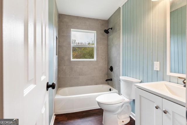 bathroom featuring vanity, wood finished floors, bathtub / shower combination, and toilet