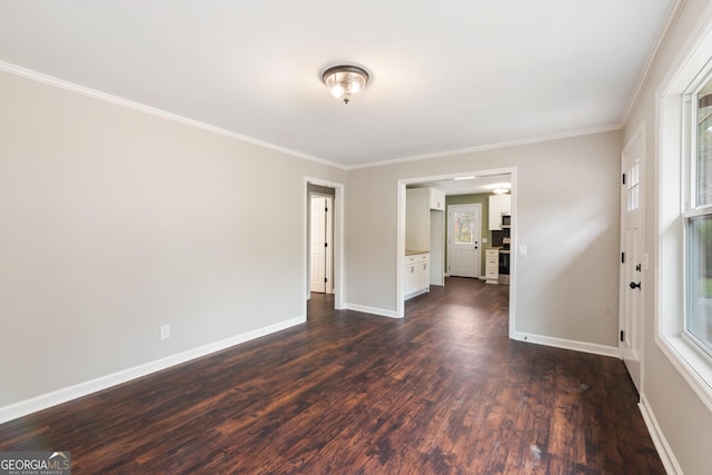 empty room with crown molding, dark wood-style flooring, and baseboards