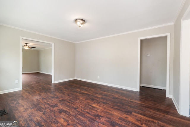 spare room with dark wood-style floors, baseboards, and ornamental molding