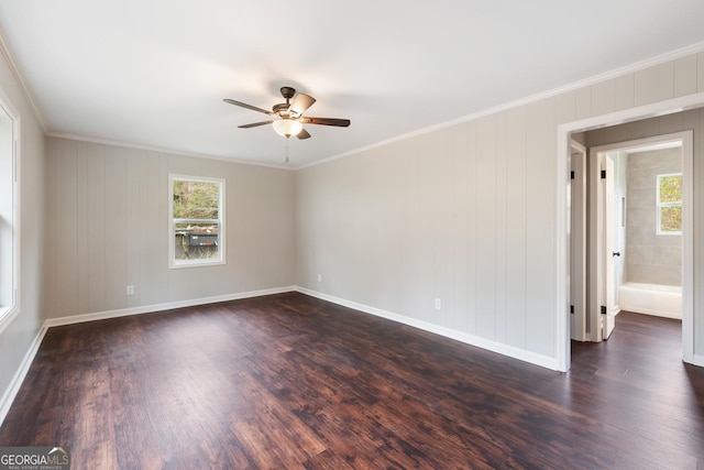 unfurnished room featuring crown molding, dark wood-style flooring, and a healthy amount of sunlight