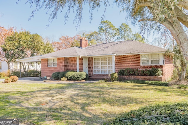 single story home with brick siding, a chimney, and a front lawn