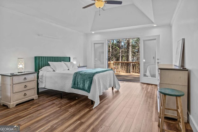 bedroom featuring access to exterior, lofted ceiling, a ceiling fan, and wood finished floors