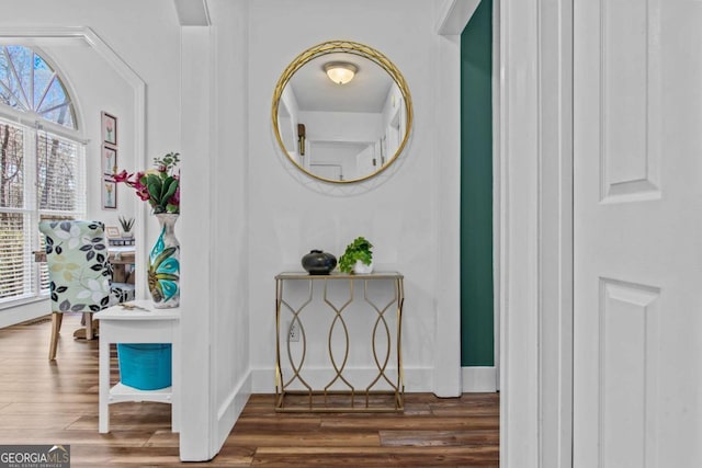 interior space featuring wood finished floors and baseboards